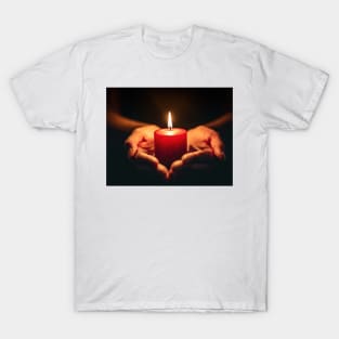 Small red candle burning held in hands on black background generative ai T-Shirt